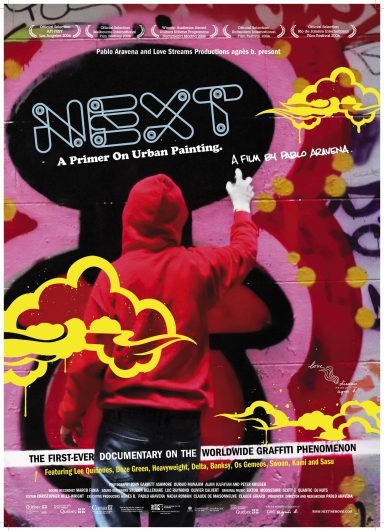 A person in a red hoodie gestures against a vibrant graffiti background.